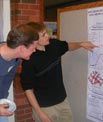 Students discussing a poster.
