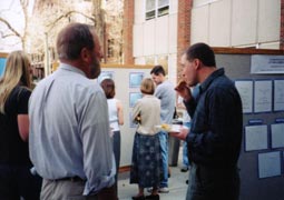 Faculty and staff looking at posters.